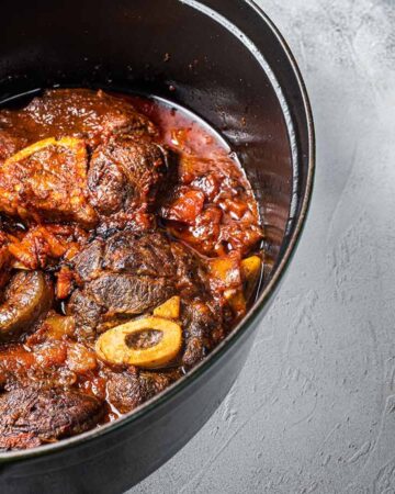 beef shanks in the cooking pot with white backround